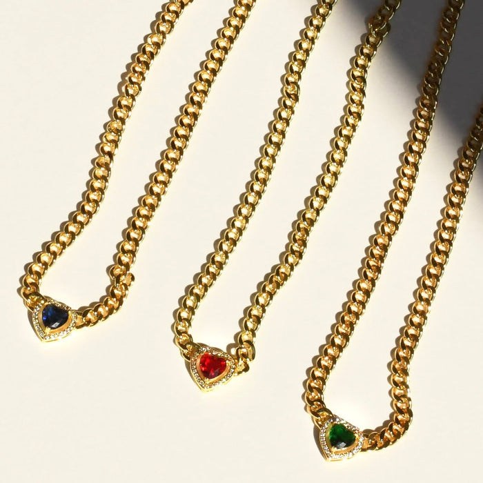Dainty gold layered necklace, wholesale jewelry for women's boutiques, statement accessory, boutique wholesale jewelry, waterproof necklaces, statement gold necklace, trendy gold jewelry, hypoallergenic jewelry, tarnish-free necklace, gold chunky chain necklaces with blue, red, and green heart-shaped gemstone pendants