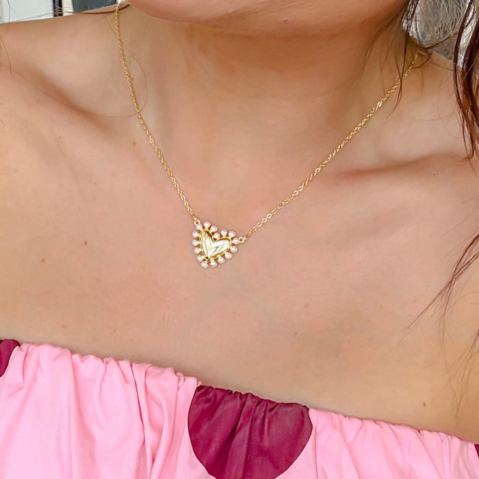 Dainty gold layered necklace with a pearl-trimmed heart pendant, trendy statement accessory for wholesale jewelry for women’s boutiques, boutique wholesale jewelry, waterproof necklaces that are hypoallergenic and tarnish free