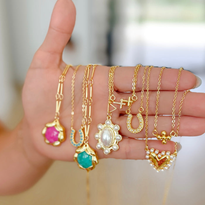 Dainty gold layered necklace with a pearl-trimmed heart pendant, trendy statement accessory for wholesale jewelry for women’s boutiques, boutique wholesale jewelry, waterproof necklaces that are hypoallergenic and tarnish free