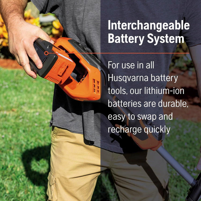 Person holding a Husqvarna battery-powered tool with text about interchangeable battery system.