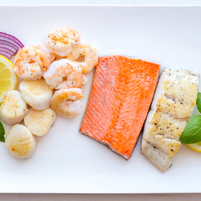 Selection of paleo fish including Wild Sockeye Salmon Fillet, Deveined shrimp, scallops and north atlantic haddock