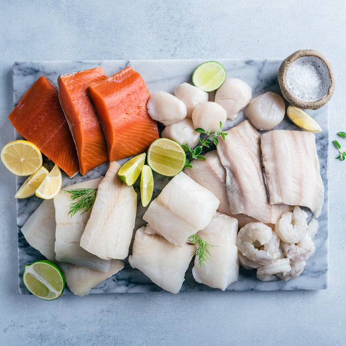shrimp, scallops, alaskan salmon and haddock on plate