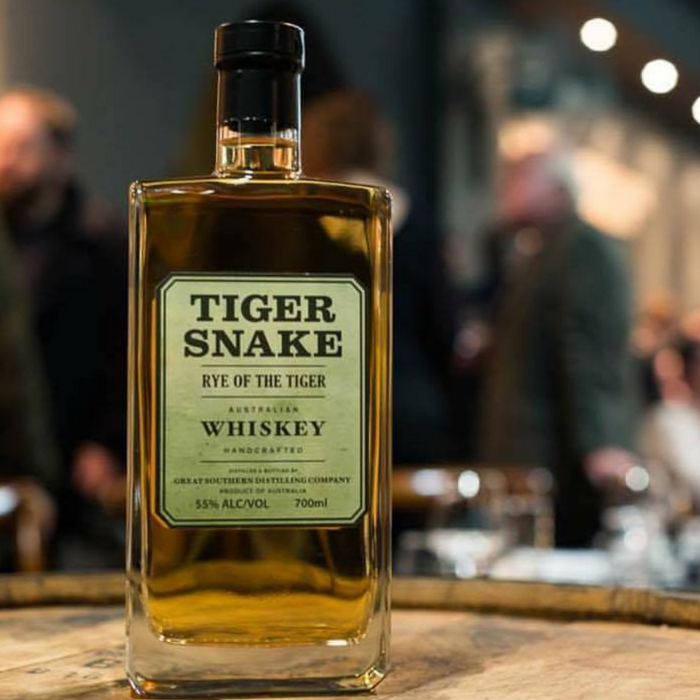 Tiger Snake Rye of the Tiger 700ml bottle on top of a barrel